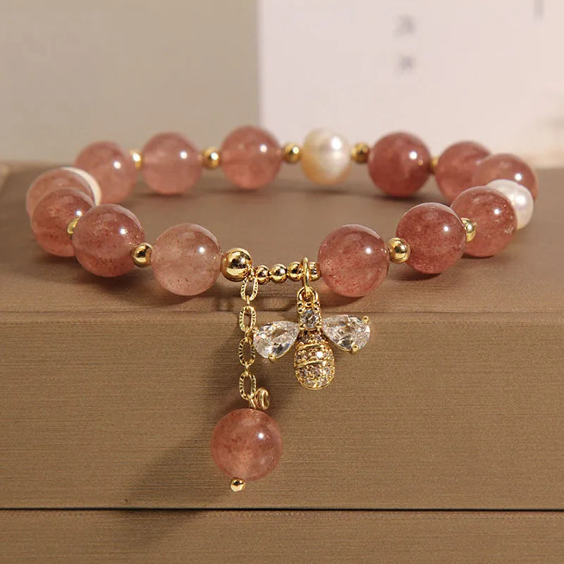 Women's bracelet with pink strawberry quartz stones, white freshwater pearls, and sparkling zircon on an alloy chain.
