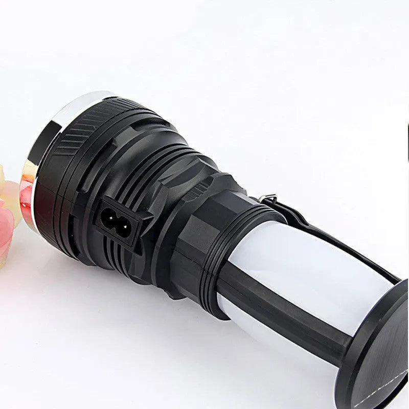 Black solar-charging LED emergency flashlight with USB port for outdoor use.