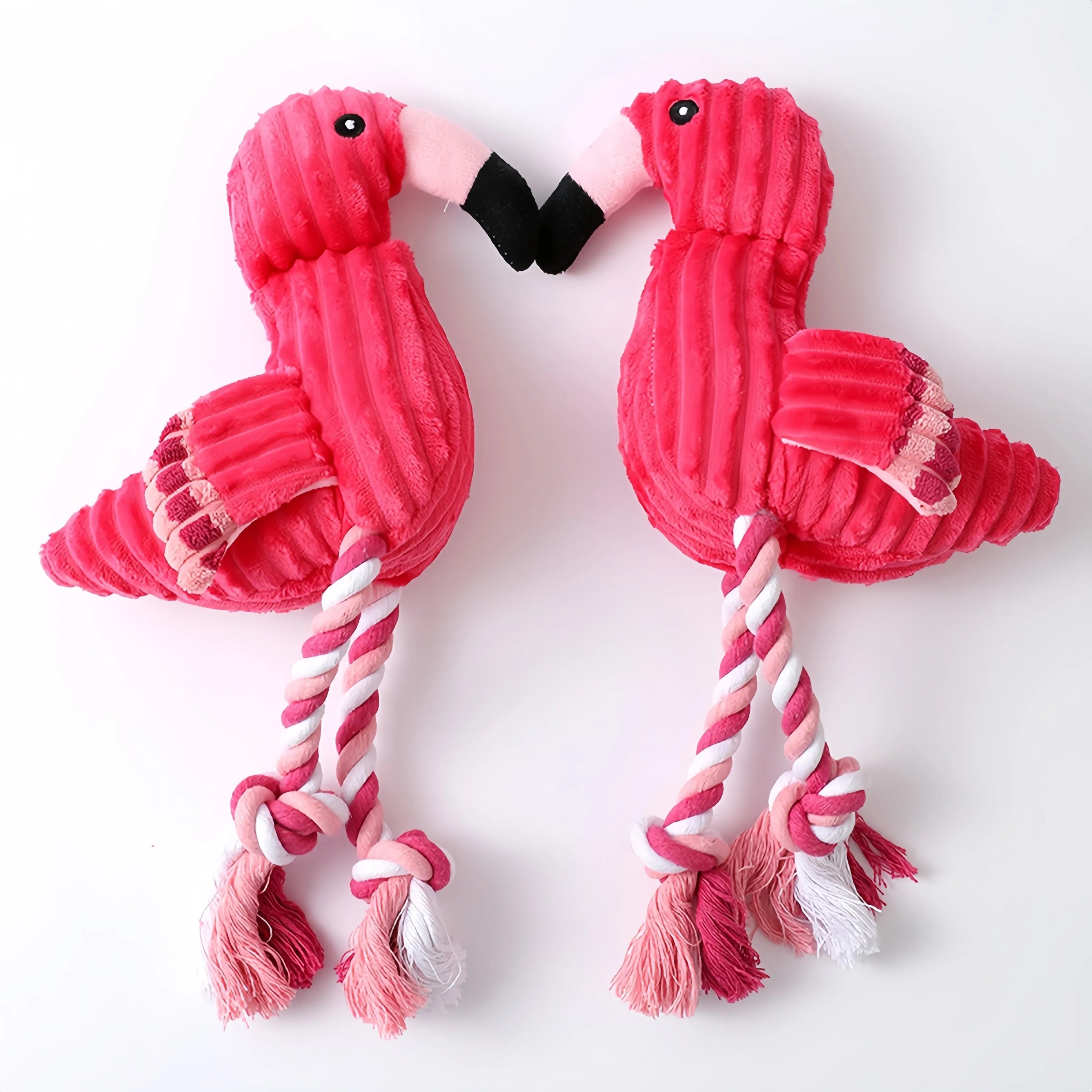 Pink corduroy animal-shaped plush dog toy with a squeaker inside on a neutral background.