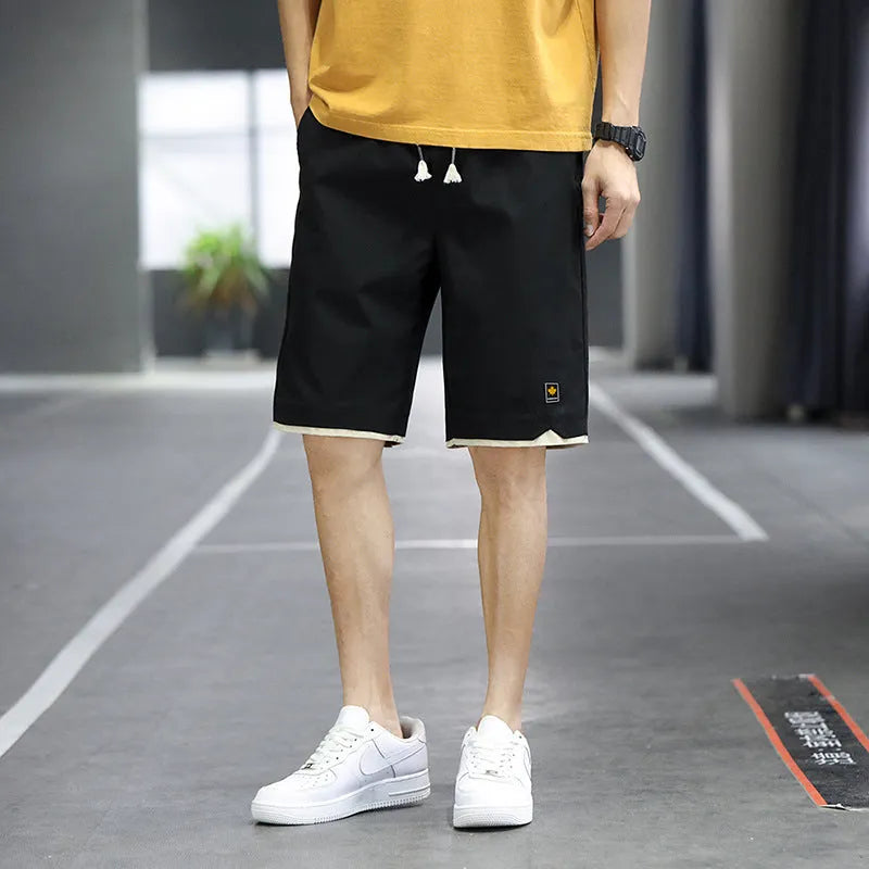 Korean style straight leg loose beach shorts in polyester, shown in green on a mannequin.