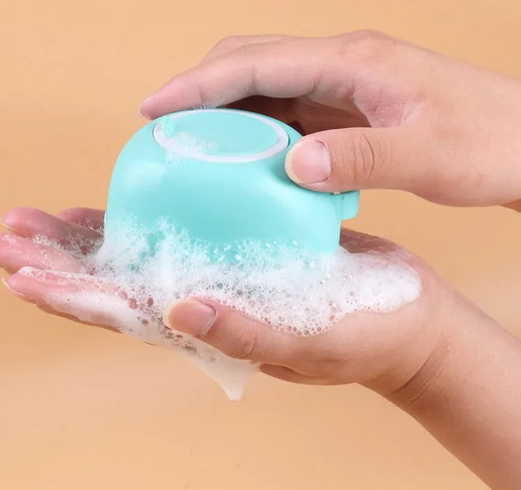 Silicone dog bath brush with finger loops in blue, pink, and yellow colour options
