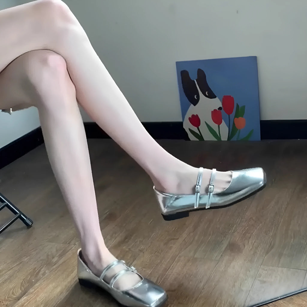 Women's silver leather Mary Jane ballet pumps with cross buckle strap and flat low heel.