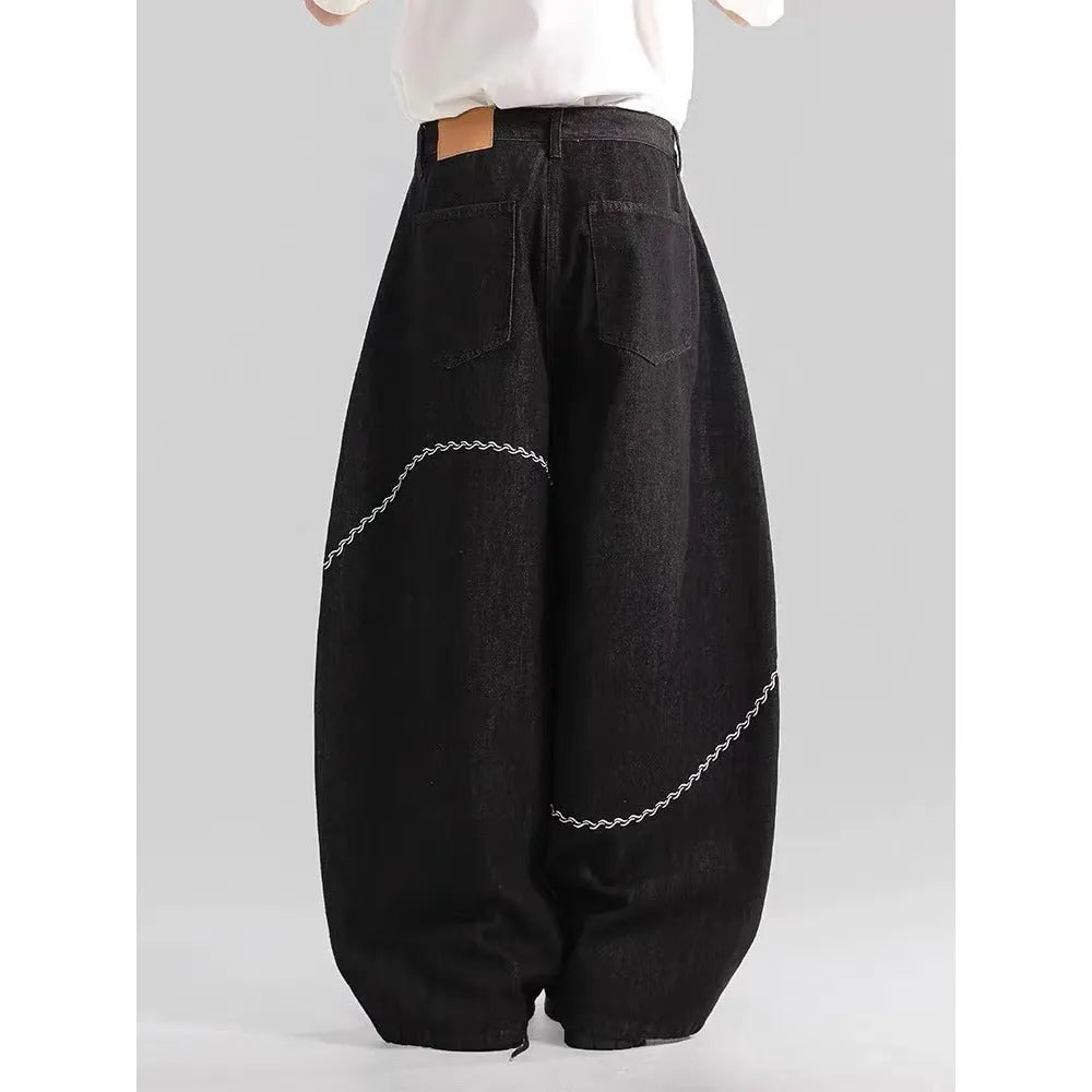 Black straight leg denim trousers with micro elastic waistband and zip fly placket detail