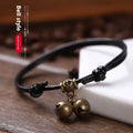 A nylon rope dog collar with a brass buckle shown alongside a version with a brass bell, in black, red, and coffee colours.