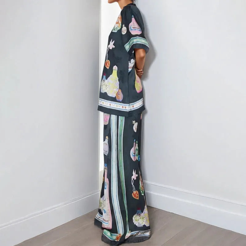 Black women's co-ord set with cartoon animation print, featuring a cardigan and trousers.