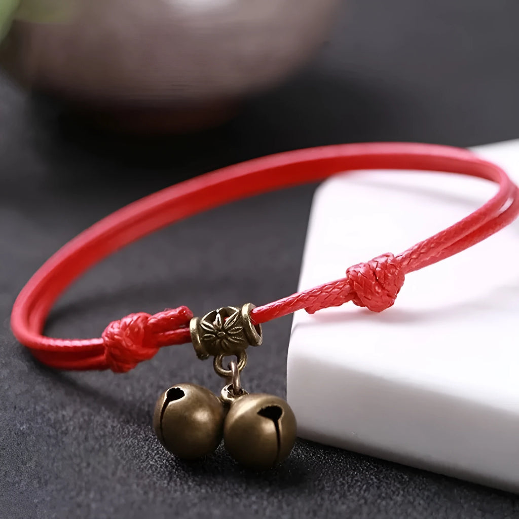 A nylon rope dog collar with a brass buckle shown alongside a version with a brass bell, in black, red, and coffee colours.