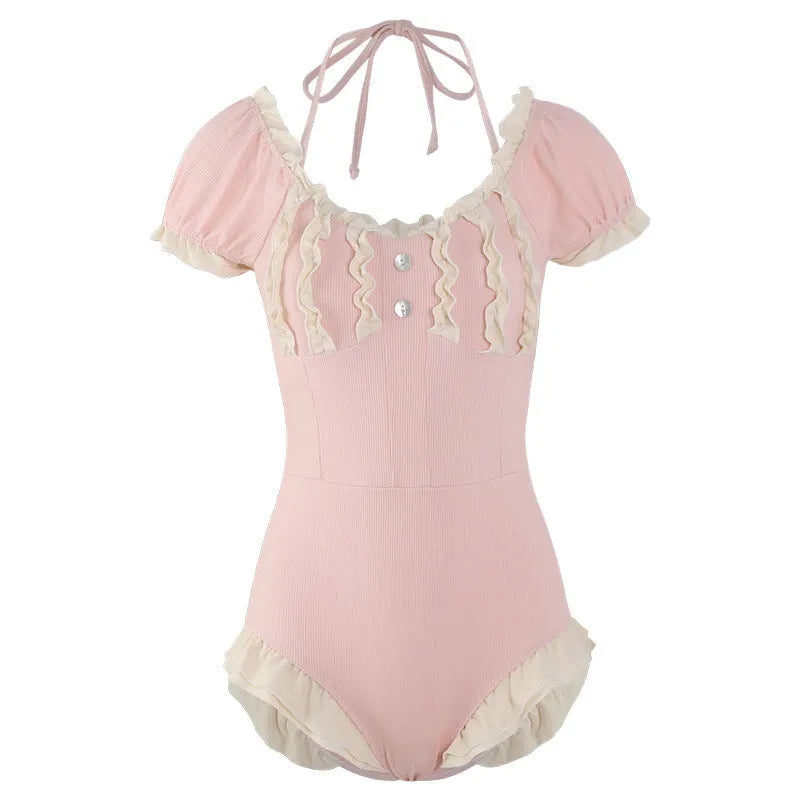 Pink women's conservative one-piece swimsuit with a Siamese design detail on a mannequin.