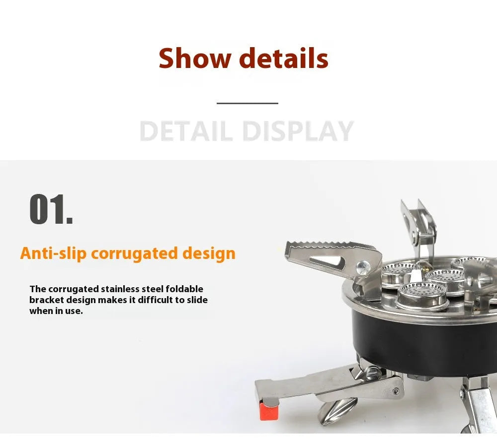 Silver portable folding camping stove with extended copper gas hose, shown on a wooden picnic table.