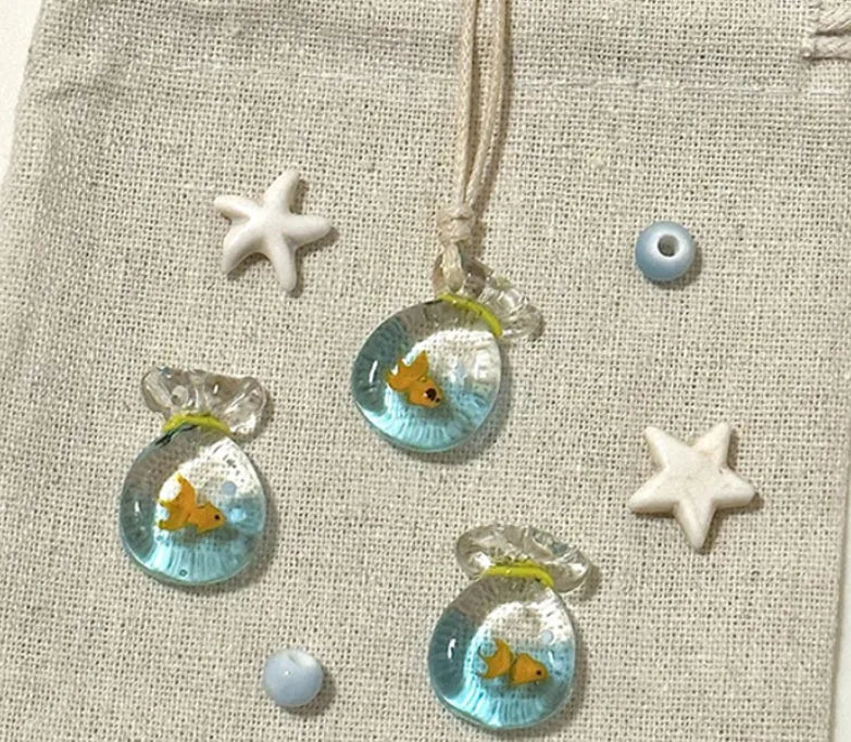 Women's necklace with coloured glaze skirt joker pendant on a beige cotton and linen chain, 45cm long.