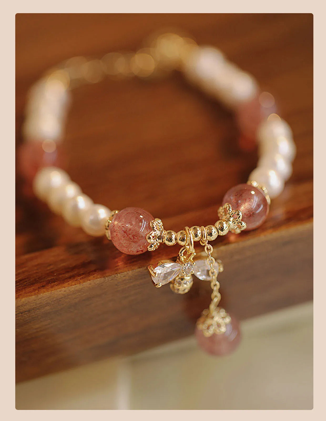 Strawberry quartz crystal bead bracelet for women with a central bow decoration.