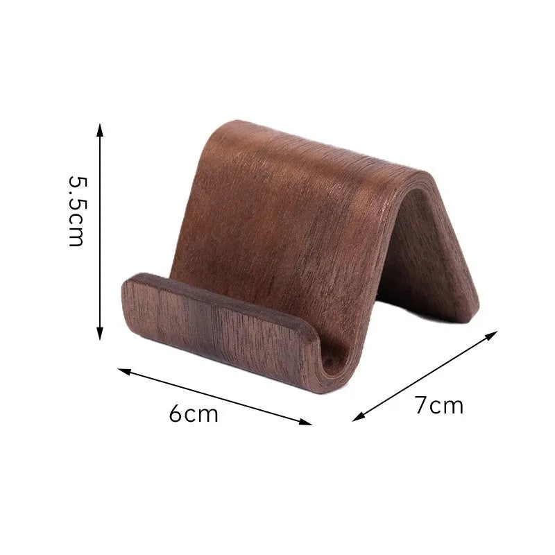 Walnut wooden mobile phone bracket on a desk, with a smartphone placed in the stand