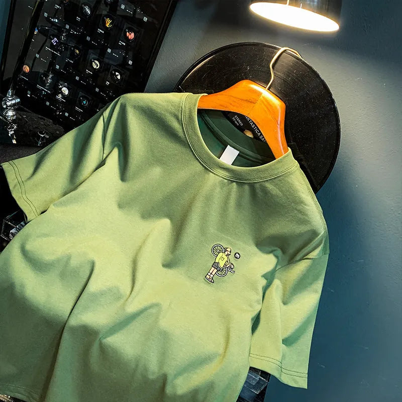 Green loose-fit men's short sleeve T-shirt with a printed design on the front.