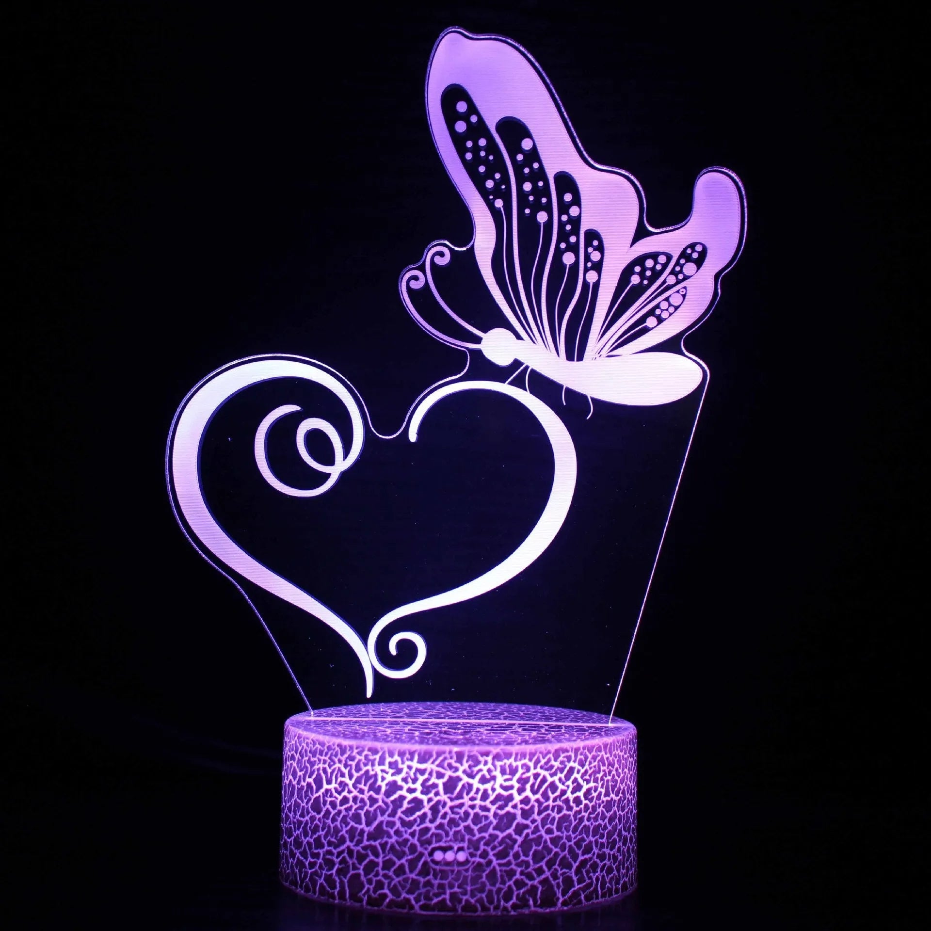 Small blue 3D acrylic USB table lamp with cracked base design lit up on a wooden desk.