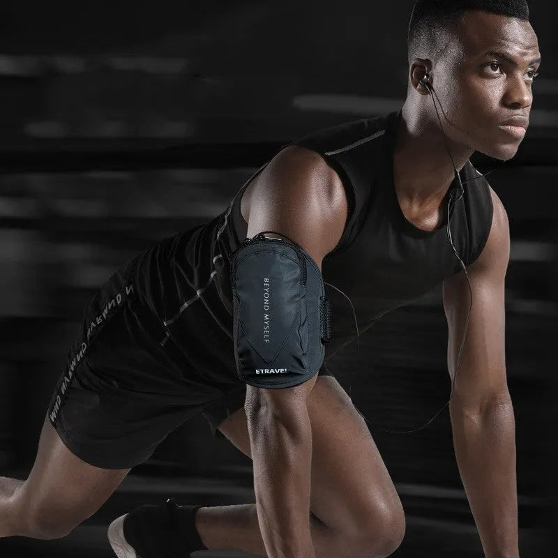 Black reflective running arm bag with adjustable strap, shown on a runner's arm at dusk.
