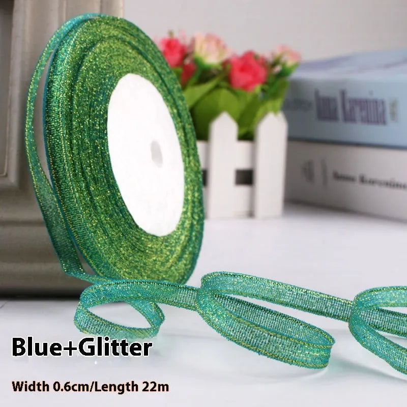 Roll of narrow 0.6cm wide polyester gift ribbon in a multicolour pattern.