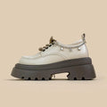 White platform Mary Jane shoes with a chunky block heel and front lace-up detail.