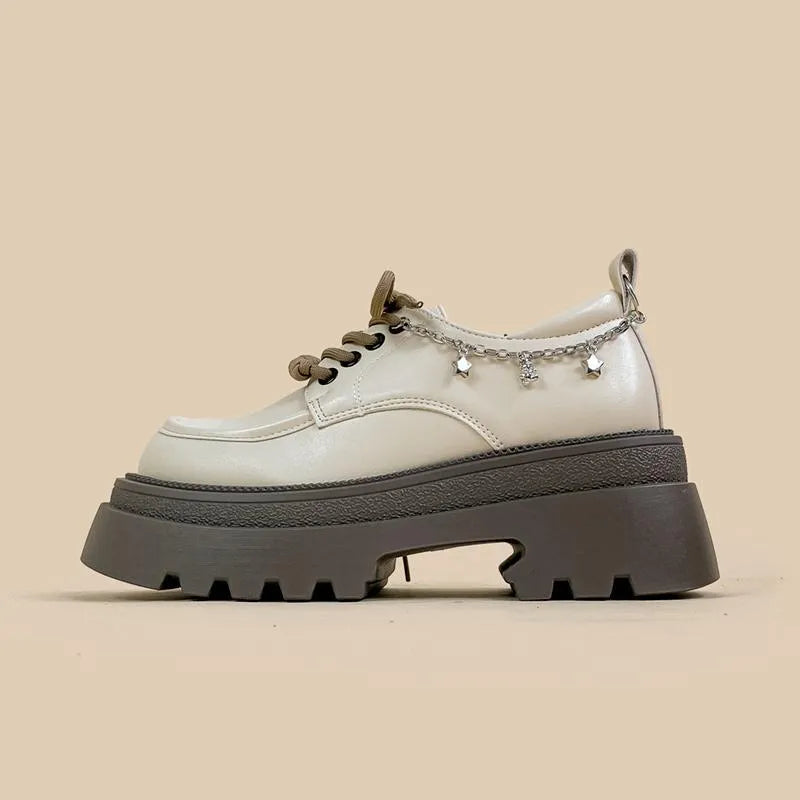 White platform Mary Jane shoes with a chunky block heel and front lace-up detail.