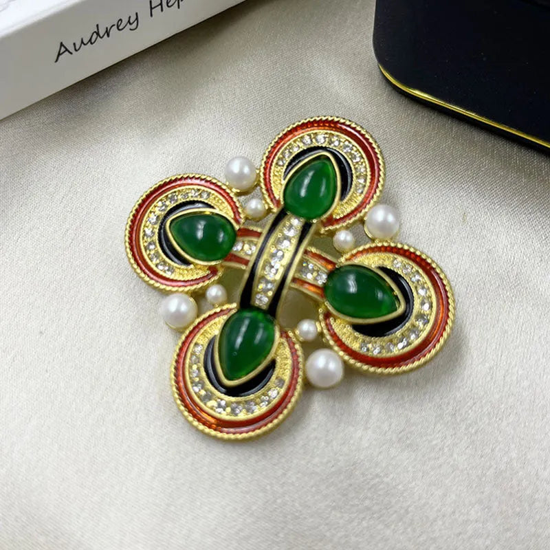 Close-up of a vintage medieval baroque cross brooch in zinc alloy with crystal accents, showing intricate detail.
