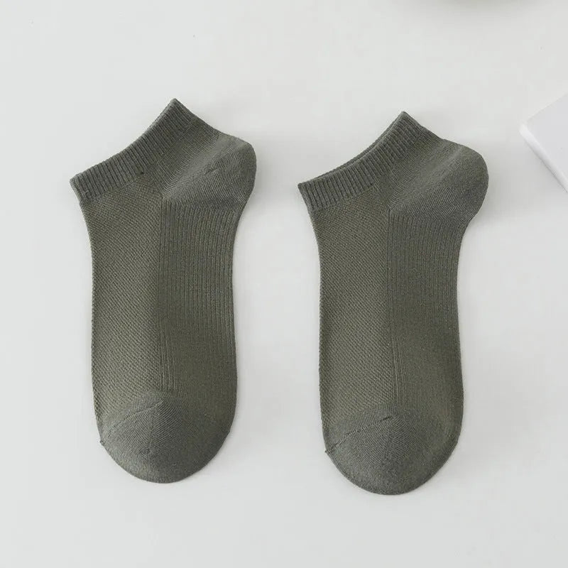 A pair of solid colour low-cut men's boat socks made from breathable polyester fabric.