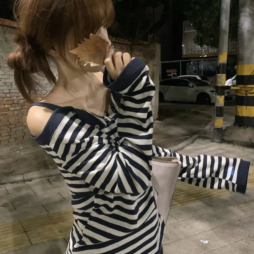 Dark blue women's oversized long-sleeve t-shirt with embroidery and stripe details on a hanger.