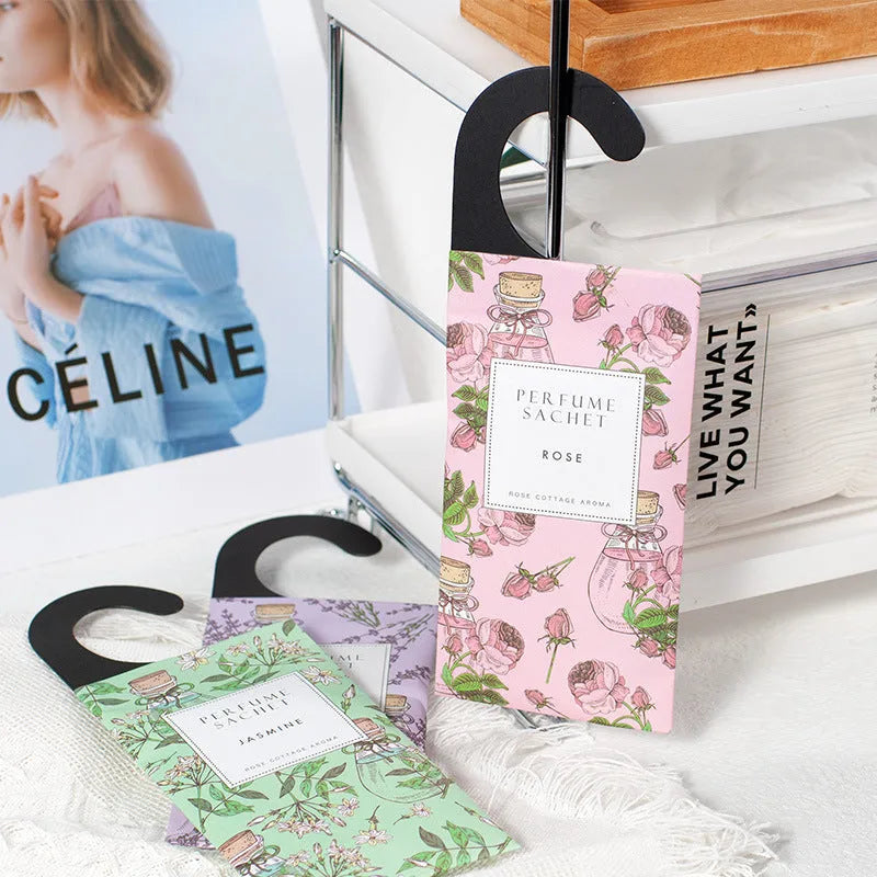 Pack of five household wardrobe sachets with lavender, rose, jasmine, sandalwood, vanilla, apricot blossom aromas on a shelf