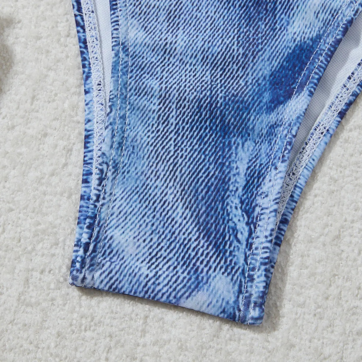 Women's denim blue printed bikini set with strap detail, made from nylon spandex fabric.
