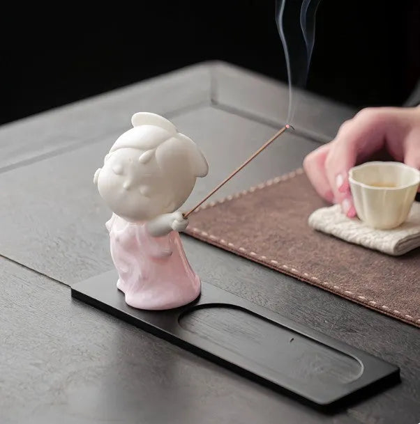 Ceramic cute court attendant incense burner decoration in fresh style on a plain background.