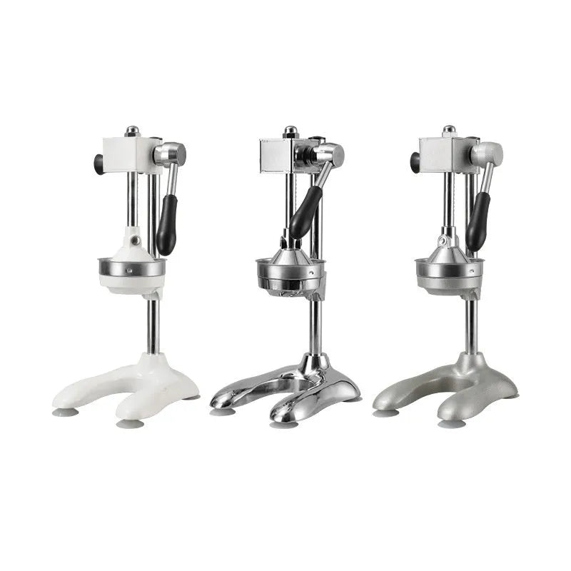 Vertical stainless steel and zinc alloy manual citrus juicer on a kitchen counter.