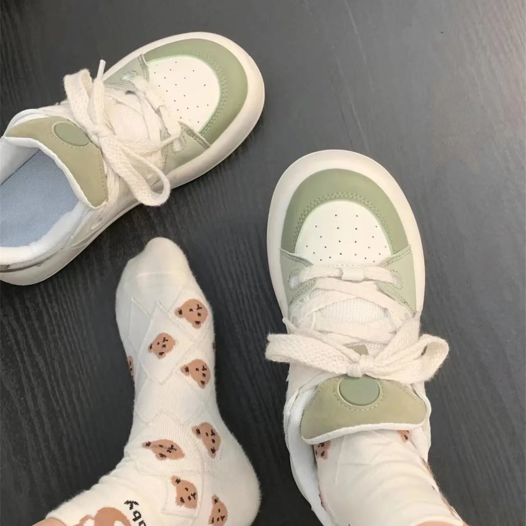 Green women's casual shoes with round toe, flat heel, and breathable mesh upper.