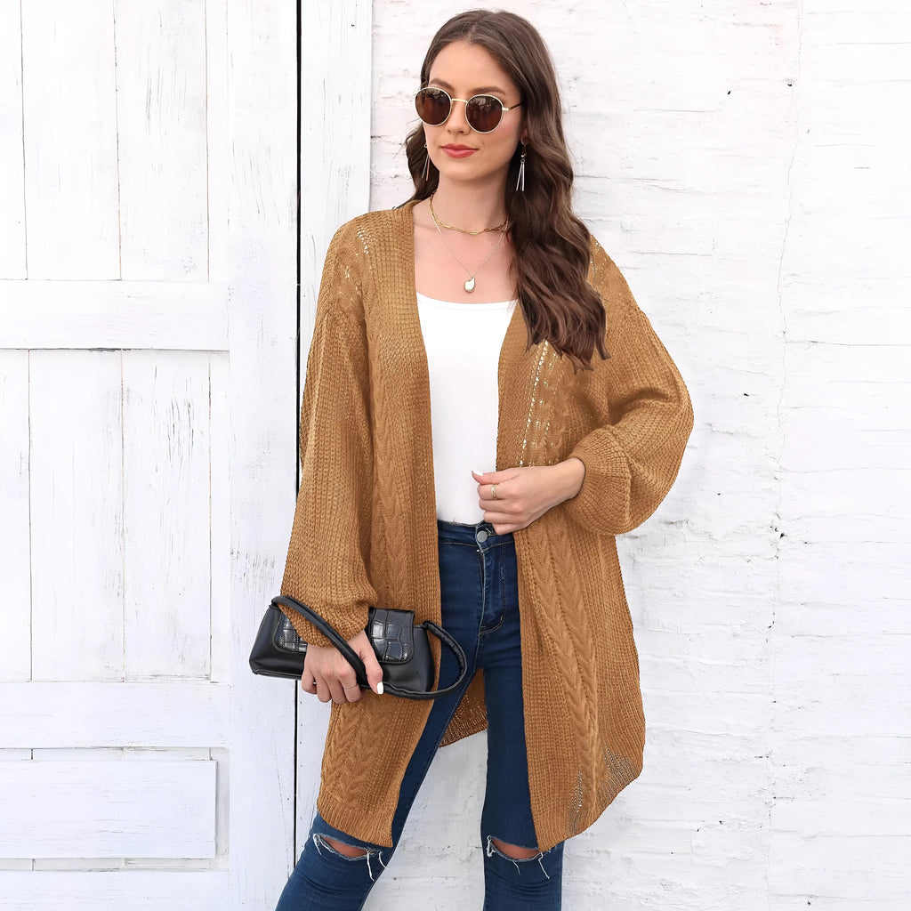 Women's loose acrylic sweater coat in a solid colour, shown in a casual style.