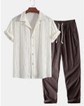 Lightweight linen-feel casual suit set with camouflage print trousers and a short-sleeved lapel shirt.