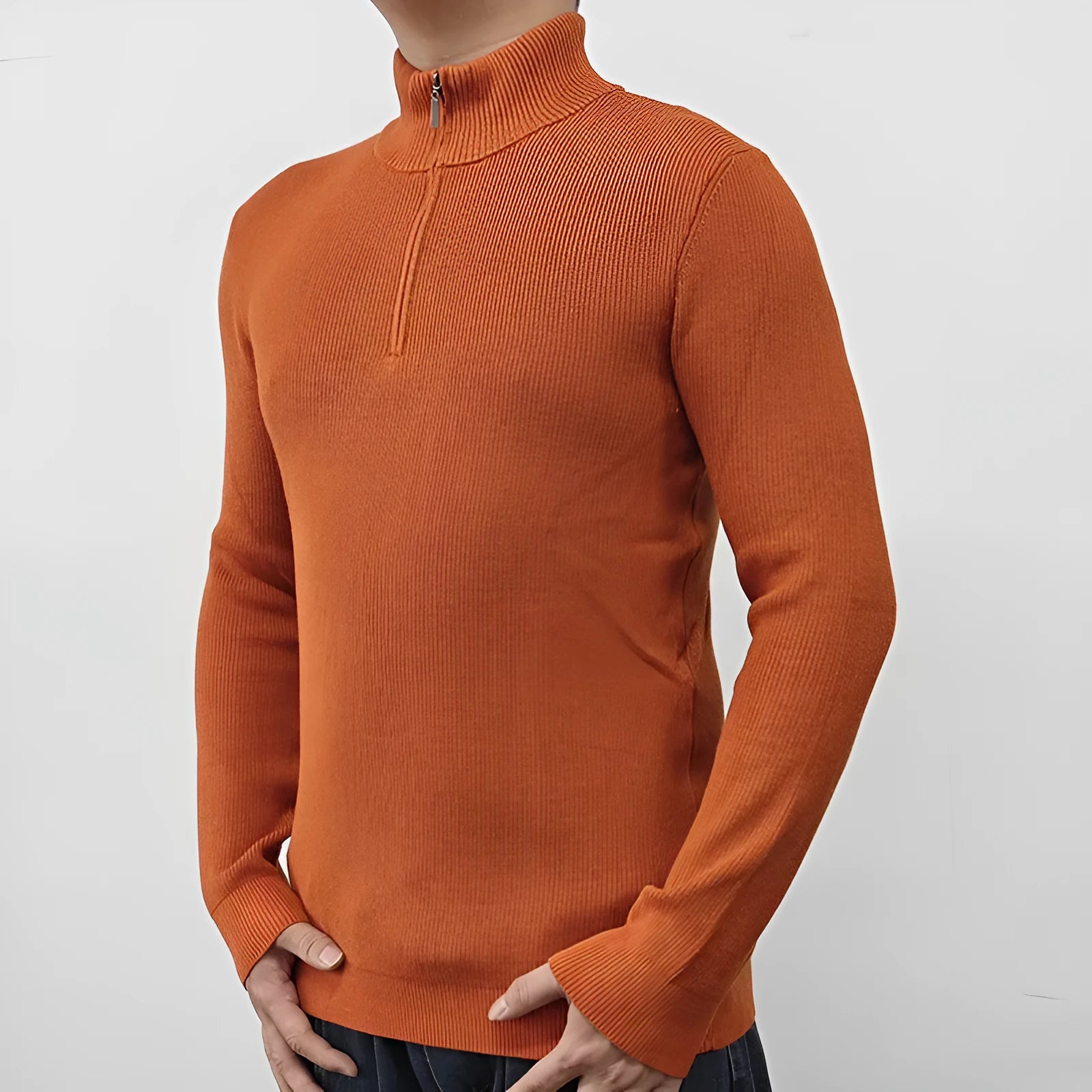 Man wearing a grey zip-front half-turtleneck sweater, a casual long-sleeve pullover.