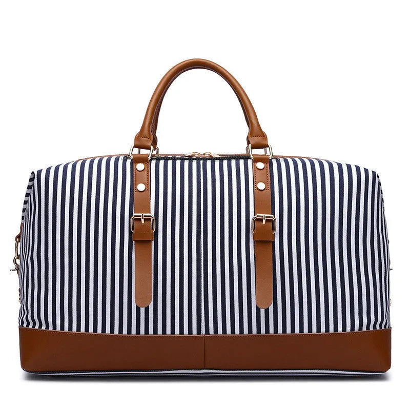 Large blue striped canvas travel bag with single shoulder strap, soft handle, zip opening, and internal pockets.