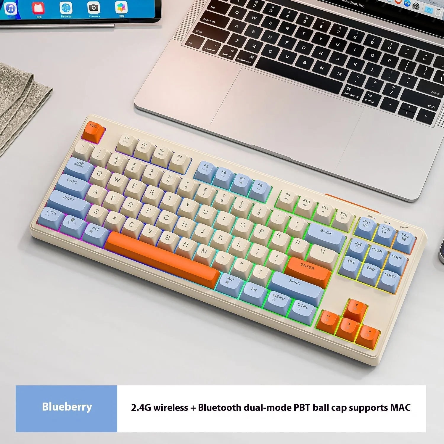 Compact wireless Bluetooth keyboard in blueberry colour with USB receiver and cable on a desk.