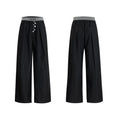 Straight-leg high-waisted casual trousers with a button-open front seam detail in black.