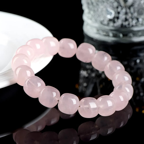 Pink bamboo crystal barrel bead bracelet with 11-12mm beads on a wrist.