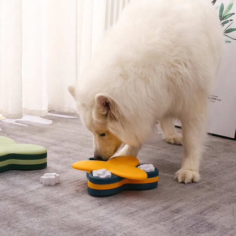 Green and yellow interactive dog puzzle toy slow feeder bowl with nine bone-covered compartments.