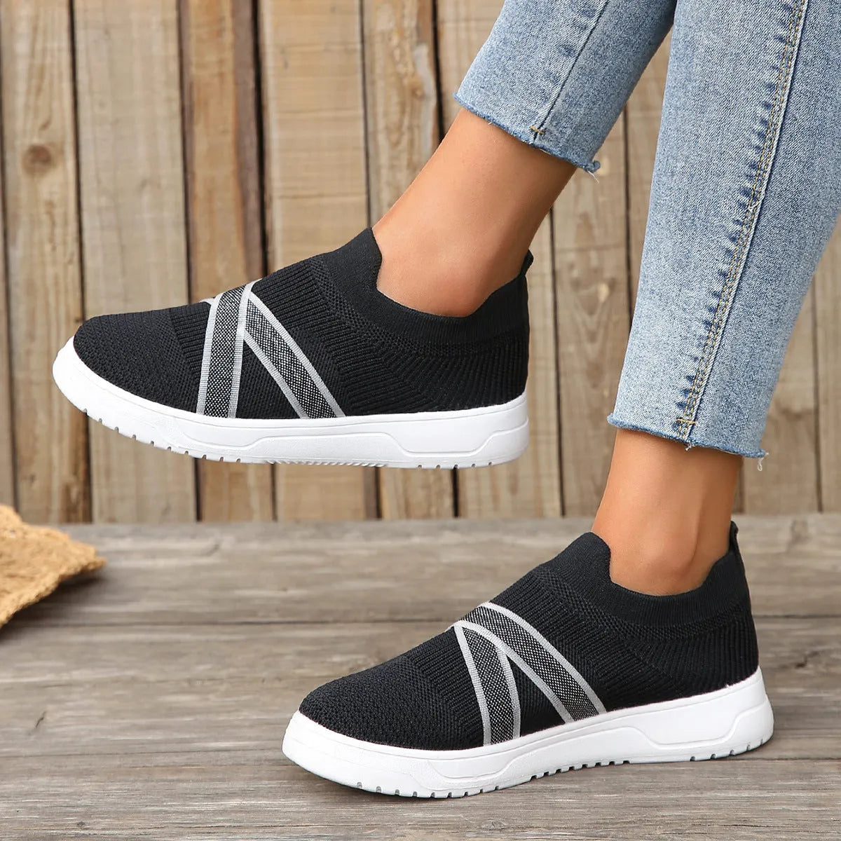 Black women's flyknit mesh shoes with flat rubber sole and tassel detail