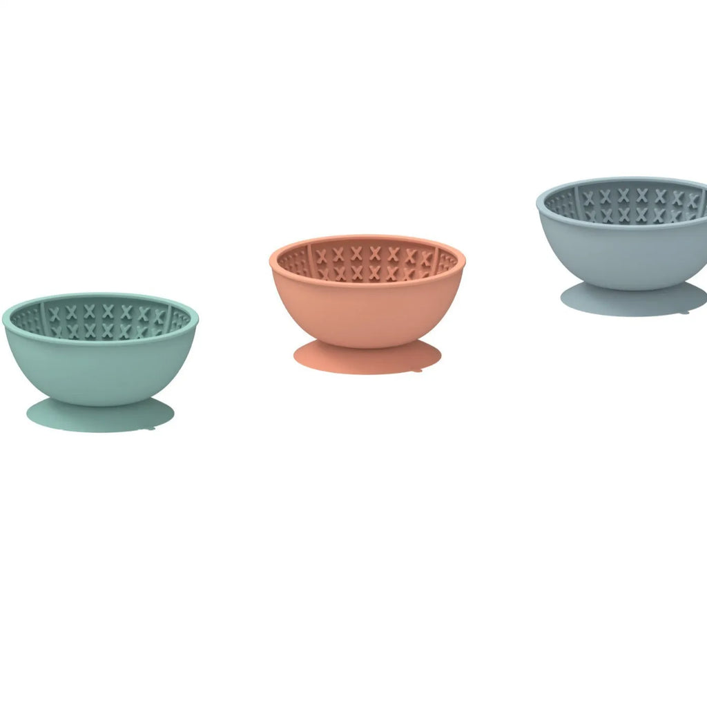 Cyan silicone pet licking mat slow feeder bowl with suction cup base on a floor