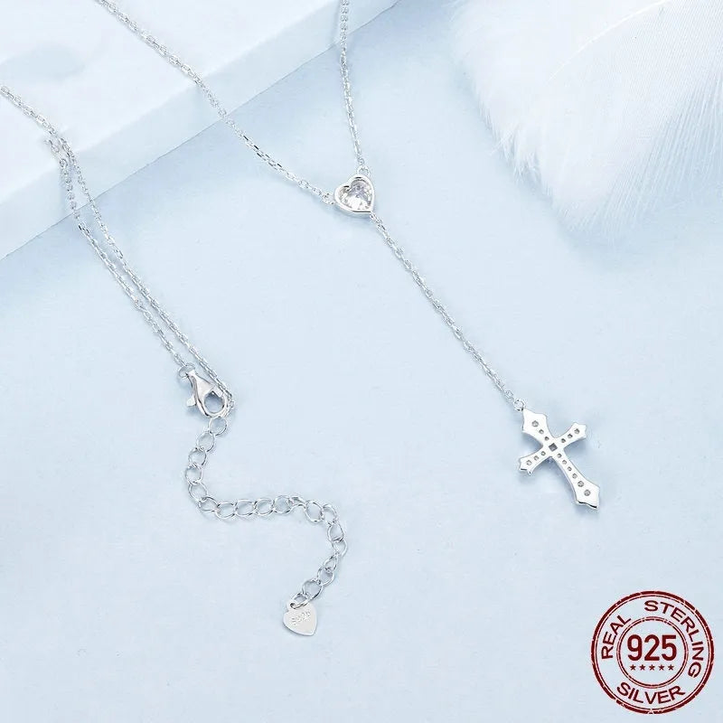 Women's silver love cross necklace with V-neck pendant on O-ring chain.