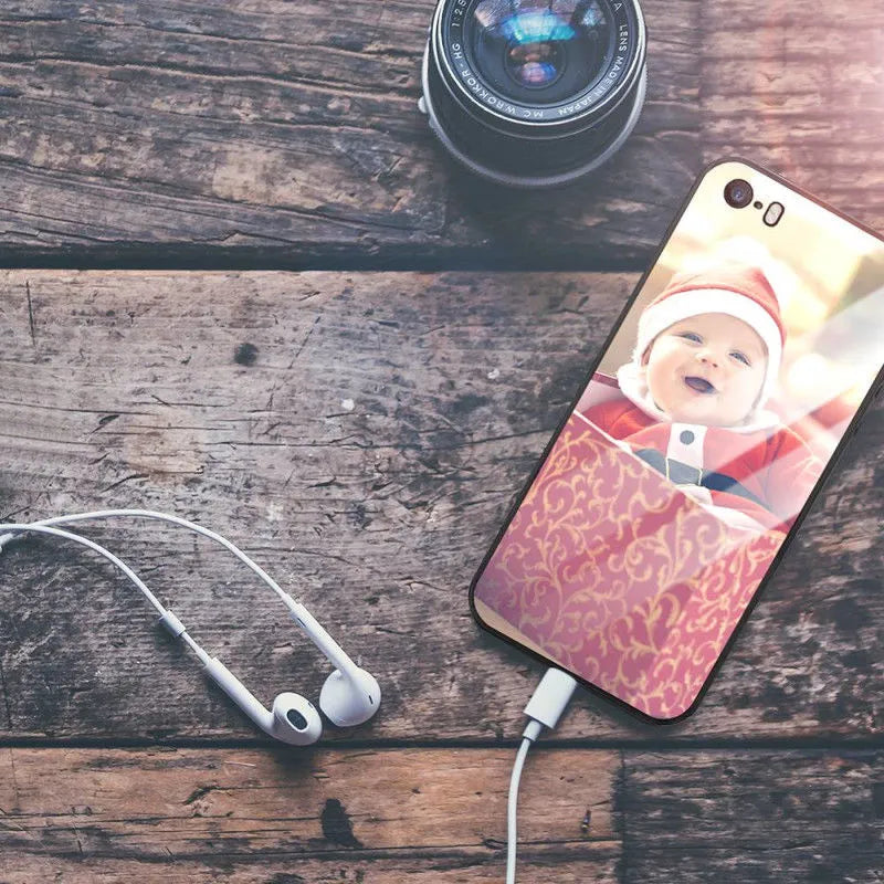 Patterned ultra-thin iPhone case with raised camera bumper edge on a table.