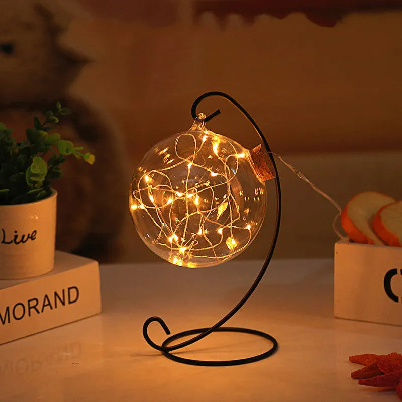 Round glass wish bottle with cork, 12 cm diameter, containing a warm white LED light strand with 20 lamp beads and folded paper stars