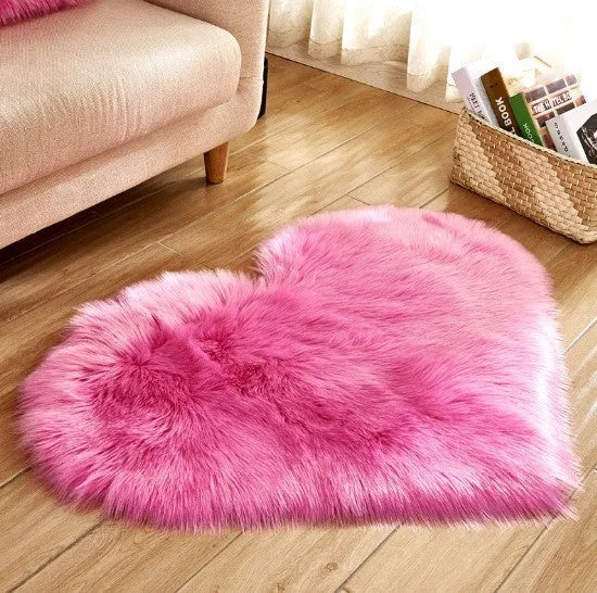 Heart-shaped plush carpet in multiple colours showing wool-like texture with 5-6 cm pile length
