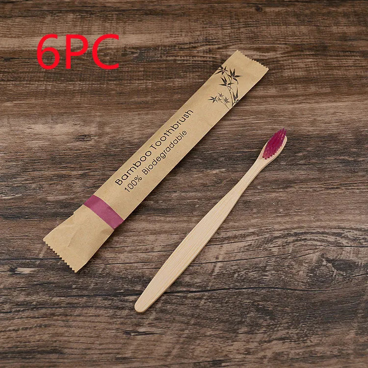 Set of ten bamboo toothbrushes with charcoal bristles in assorted colours on a plain background
