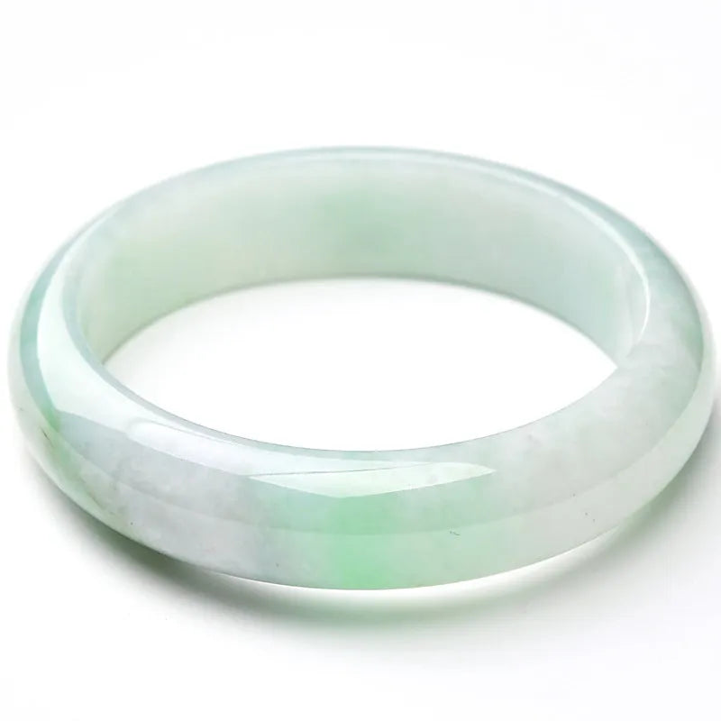 Light green jade bracelet on wrist showing natural stone texture and colour