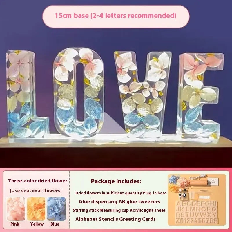 Letter small night lamp with dried flowers, blue colour, warm light, on a table
