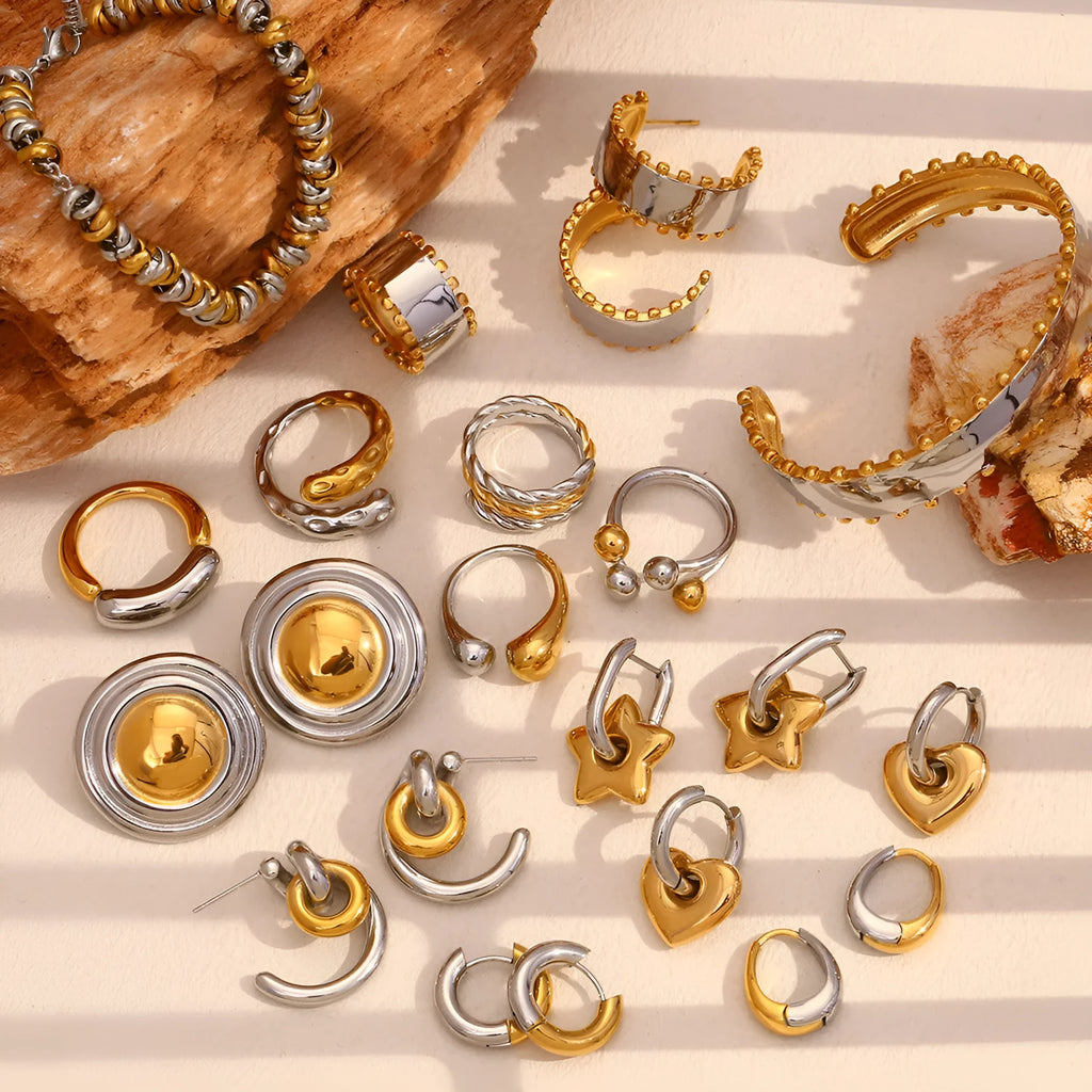 Gold geometric stainless steel jewellery set for women, showing earrings, necklace, and bracelet with electroplated finish.