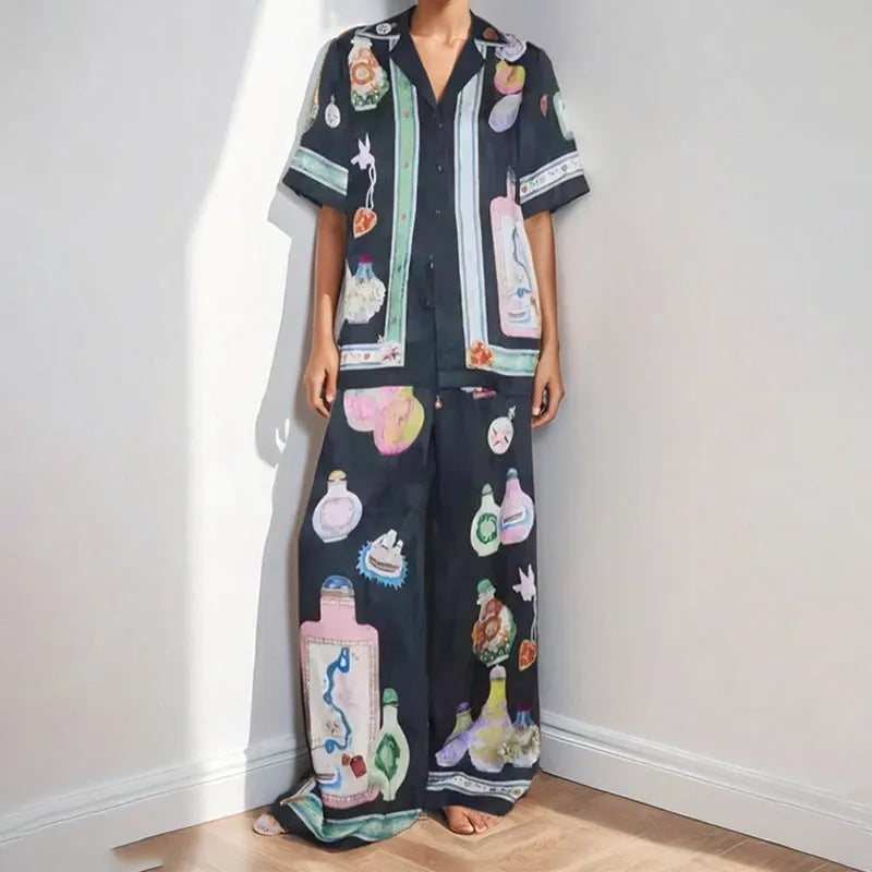 Black women's co-ord set with cartoon animation print, featuring a cardigan and trousers.