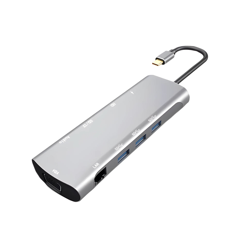 Grey aluminium USB-C docking station with HDMI, VGA, USB 3.0, and PD charge ports on a desk.
