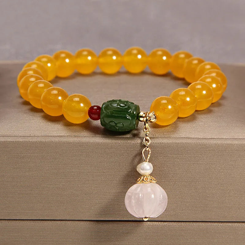 Yellow agate crystal bead bracelet on a gold silk cord with an adjustable metal clasp.